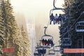 Young skiers and snowboarders on a chairlift Royalty Free Stock Photo